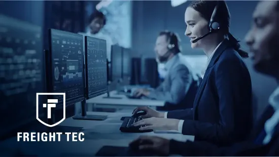 Image of a person sitting at a desk analyzing data on a computer monitor. The Freight Tec logo is overlayed in the bottom left corner.